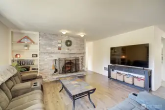 Cozy living room with wood burning fireplace.