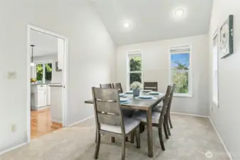 Dining room is adjacent to the island kitchen.