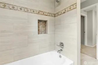 Tub and shower in upper full bath.