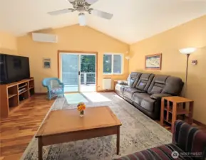 A central great room with vaulted ceilings and a slider to the sunny deck!
