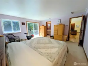 Primary suite has a full bathroom and is located off a short hallway from the great room. There is a minisplit unit in the ceiling for heat and air conditioning.