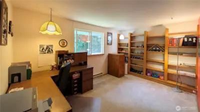 This bedroom currently serves as an office. The shelves are custom made and will remain with the home.