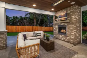 Outdoor covered living area with fireplace