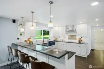 Large eating bar with plenty of seating to visit with the chef