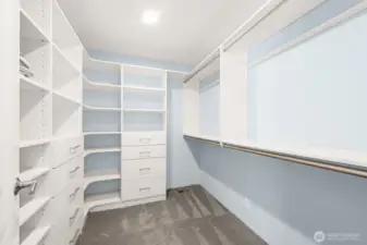 Primary suite closet with built-ins.