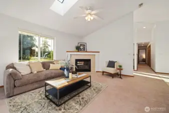 With vaulted ceilings and a skylight to let in the natural lighting, and the cozy fireplace, this room will quickly become one of your favorites.