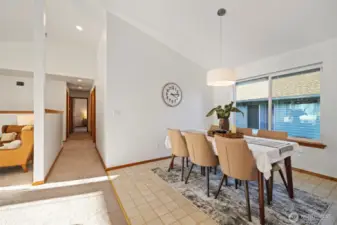 Down the hallway you'll find the primary bedroom, two additional bedrooms, full bath, laundry room and access to the garage.