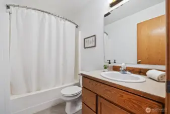 The middle, full bathroom.