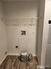 Plenty of room for a side by side washer and dryer, with space above to store laundry detergent and cleaning items.