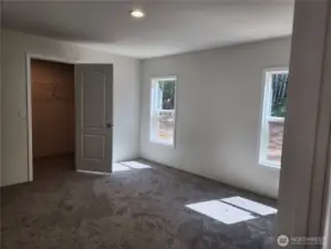 Spacious primary bedroom with a good sized walk-in closet.