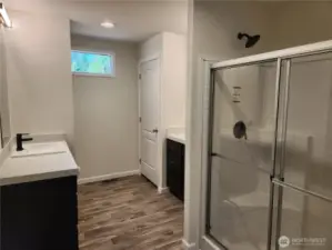 Large ensuite to the primary with his/her sinks and walk-in shower w/seat.
