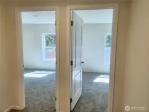 The other end of the home has 2 bedrooms and across the hallway is one more room you can use as bedroom or den/office.