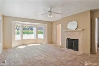 Spacious living room with tons of natural light and wood fireplace