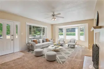 Virtually staged spacious living roomwith bay windows looking at Vandercook Park
