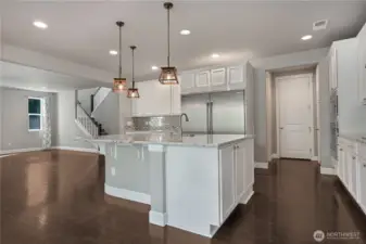 Massive open and inviting kitchen opens up to the living room. This design promotes a sense of spaciousness and connectivity, perfect for both everyday living and entertaining. The layout encourages natural flow between the cooking area and the social zone, creating a warm and welcoming atmosphere for family and guests.