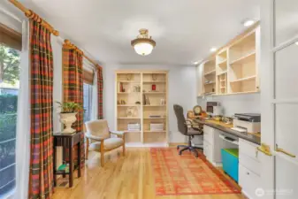A dedicated home office on the main floor offers privacy and productivity. With custom built-ins, hardwood floors, and large windows, it provides a quiet retreat for work or study.