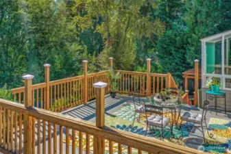 The elevated deck offers peaceful tree-lined views, creating a serene backdrop for relaxing or gathering with friends.