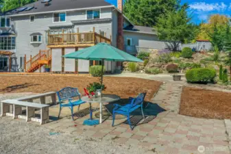Expansive backyard patio area offers multiple seating zones and space for gatherings.