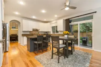 This remarkable kitchen has it all: ample storage, lots of counter space, a huge pantry, high-end stainless appliances including a Wolf range and Miele dishwasher; casual eating spaces and access to the covered patio and backyard.
