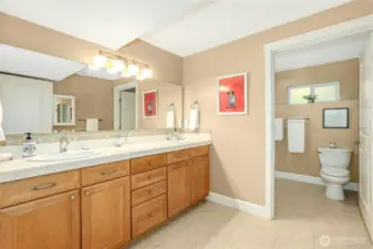 Dual sinks in bathroom.  Walk in shower has two shower heads.