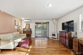 This room could serve several purposes. Here is being used as a TV room and a place to relax. Energy-efficient mini-split in this room too.