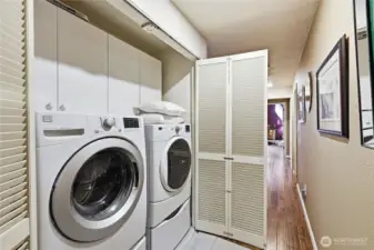 Washer and dryer on pedestals are in the hall closet. Easy to get the laundry done. The water heater is in an adjacent closet.