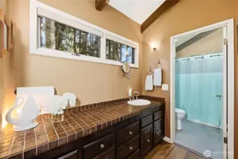 Primary bedroom vanity and door to the private bathroom.