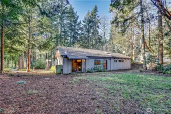 Looking from the back corner of the property at the back of the house. You can see the septic tank risers here.