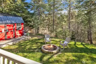 A fabulous red barn shed for all your goods or a great party space...flows out to the flat grassy yard and fire pit.