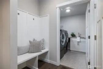 Built-in bench off the garage entry and excellent laundry room with storage and sink
