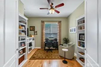 The den has double bookcases and built-in storage while still having plenty of room for a desk.