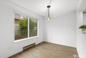 Dining area has large window view of back patio area.