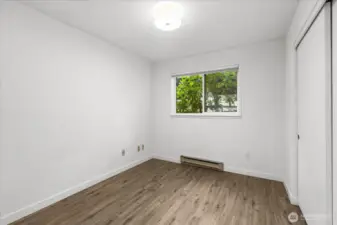 Second bedroom.  Long closet has a wonderful closet organizer.