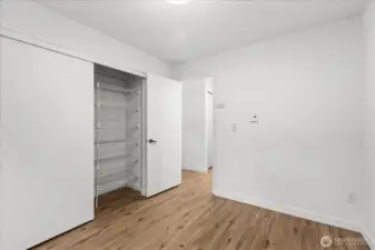 2nd bedroom with closet organizer.