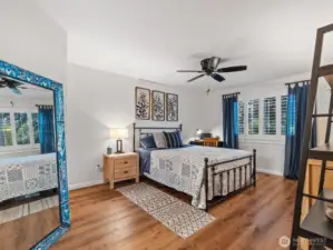 Large primary bedroom with new plantation shutters