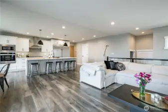 Led lighting, chef kitchen with hood, quartz countertops, long bar area, stainless appliances, pantry, good cabinet space and more