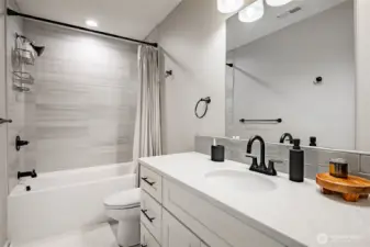 Another view, tile shower, floor, and backsplash.
