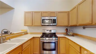 The kitchen is very efficient and has vaulted ceilings that give it incredible volume!  Again, bathed in lots of natural light.    The open concept opens to the dining and Livingroom area so your guests are always in touch but not looking at full counters while you might be cooking.  Again, the appliances are all newer and all are included!