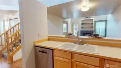 The stainless steel dishwasher is strategically located near the large double sink for easy clean up and efficiency.