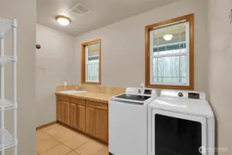 Oversized utility room with storage and workspace.