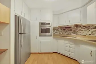 Stainless double oven, cooktop, and fridge