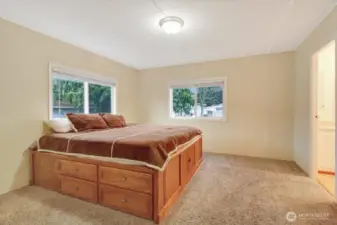 King sized bed with storage all around base and lots natural lighting