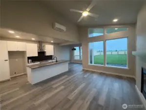 Living/kitchen with eating area in background & flooded with natural light