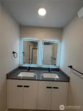 Primary ensuite with lit mirror & double sinks