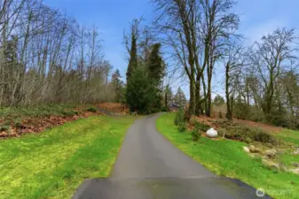 Main driveway. Lot driveway is on the left, graveled.