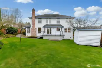 Private backyard with storage shed and garden space.