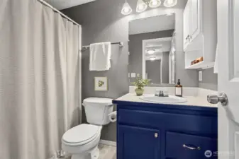 Main floor bathroom has a bathtub and is conveniently situated next to the bedrooms