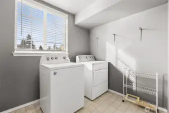 Generous sized laundry room has lots of natural light with the window