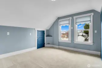 The second bedroom upstairs with a view overlooking the backyard.