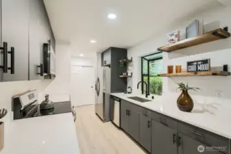 Beautiful modern kitchen with matte black panels cabinets and quartz coutnertop.